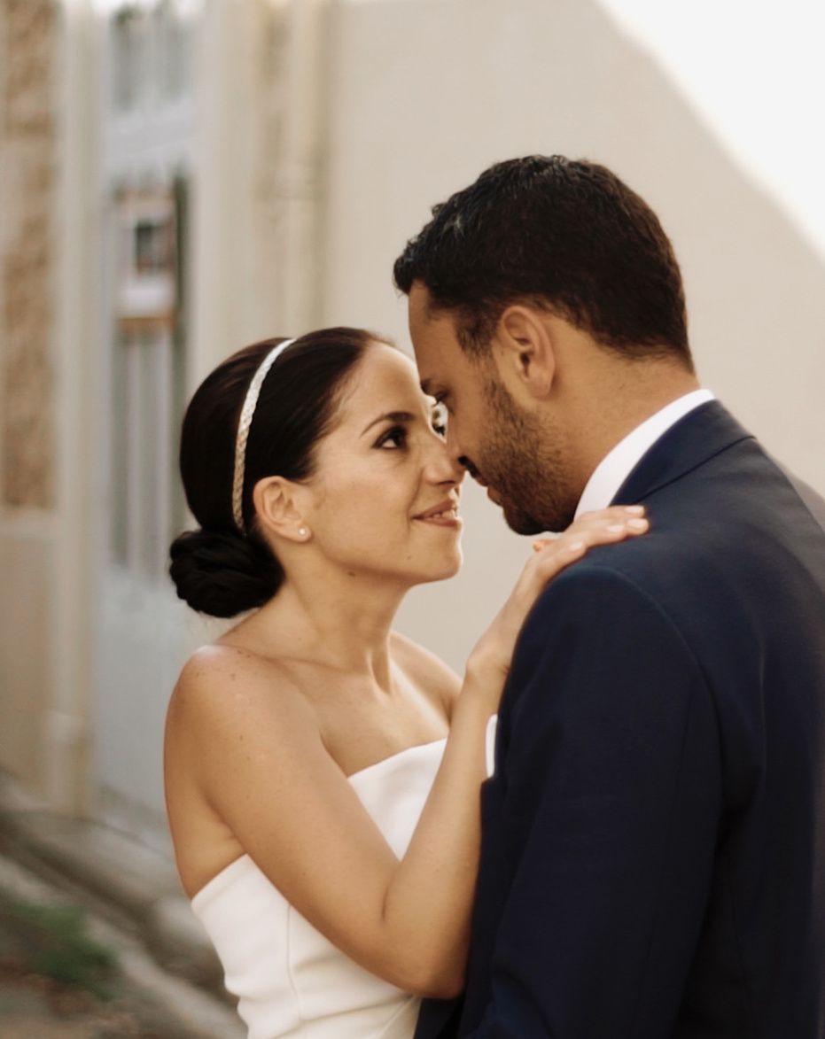 Bride and groom touching noses in a whitewashed Ibiza street