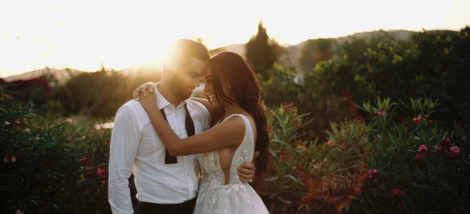Couple embracing at sunset in a garden on Ibiza